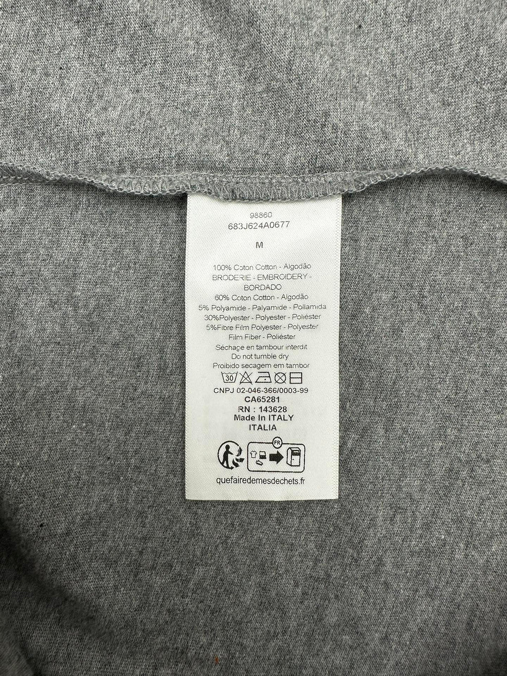 Grey T-shirt interior care label tag at collar