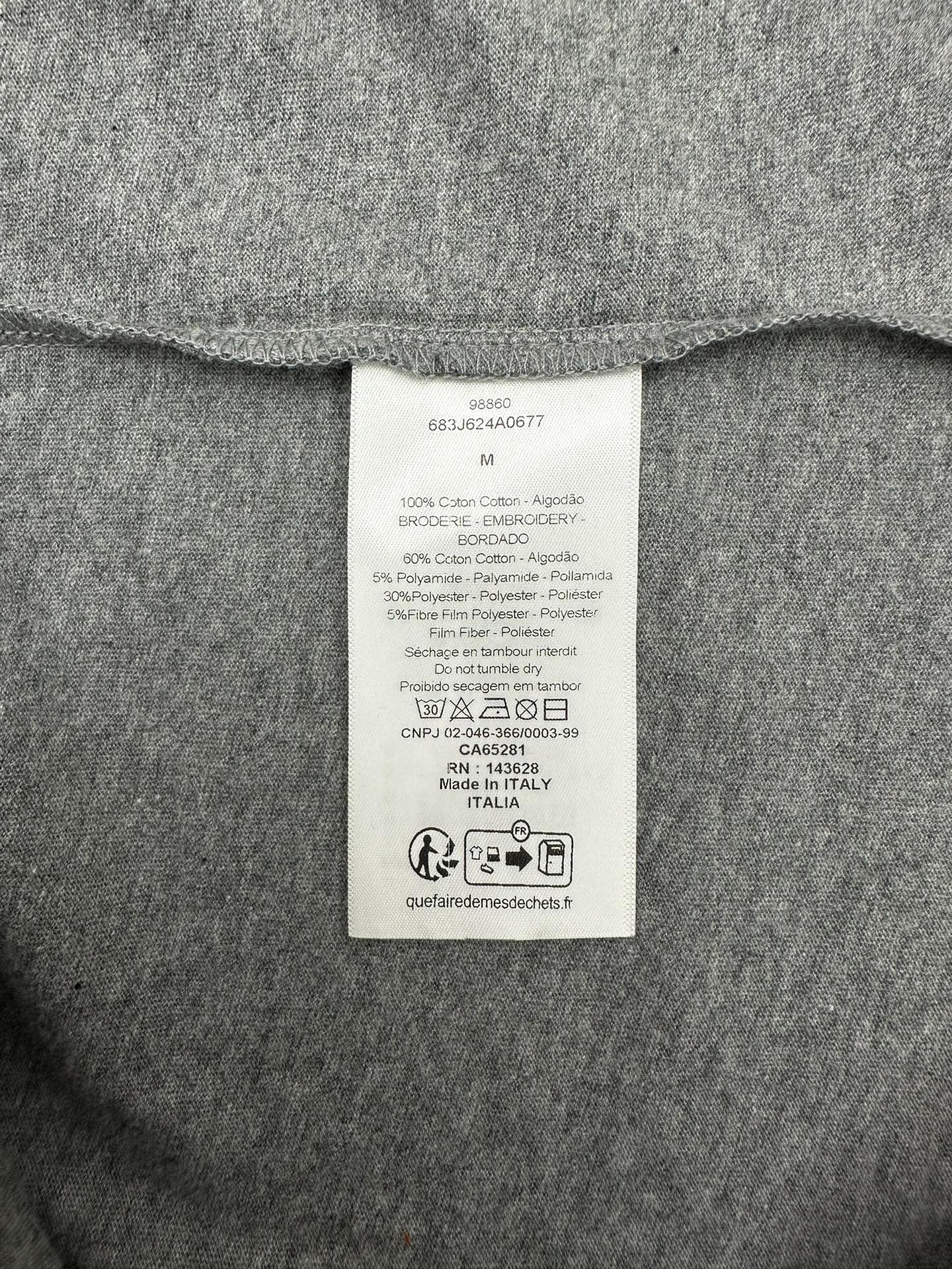 Grey T-shirt interior care label tag at collar