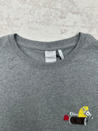 Grey T-shirt neckline with brand tag and embroidered front patch graphic