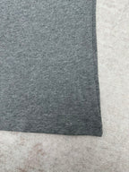 Grey short-sleeve T-shirt hem close-up, straight side seam