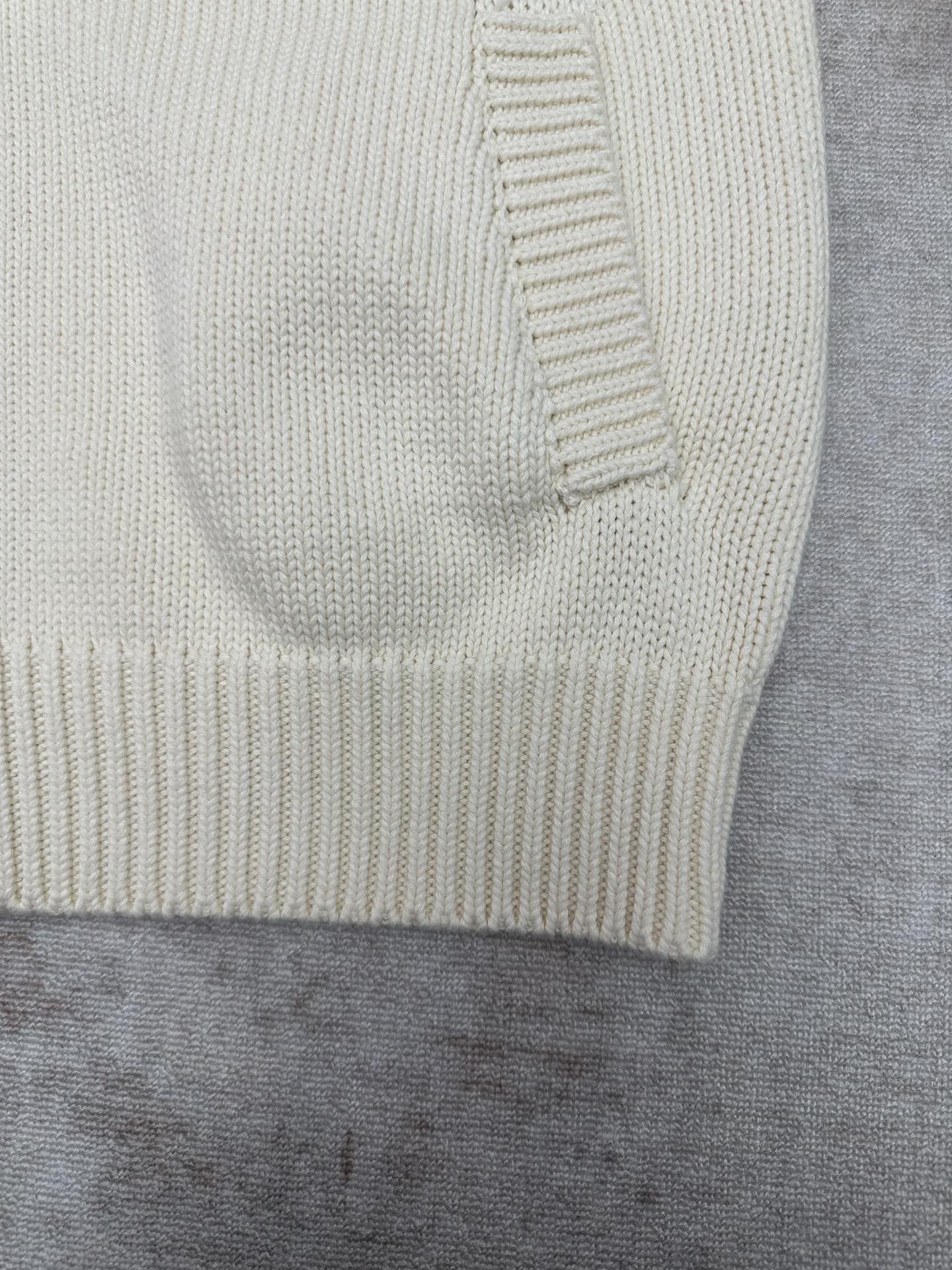 Cream knit cardigan sleeve cuff with ribbed trim close-up