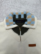 Cream cardigan collar with blue-and-tan striped trim and black V-shaped panel