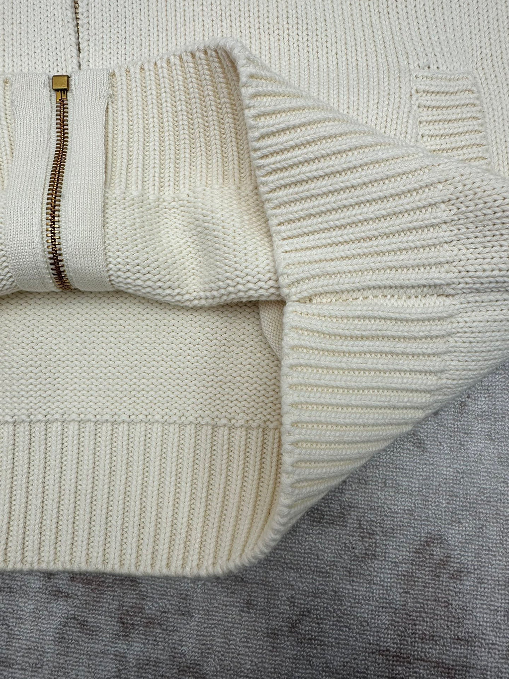 Cream knit cardigan hem with zipper edge and ribbed knit detail