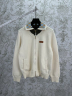 Cream knit cardigan with full zipper and striped ribbed collar detail