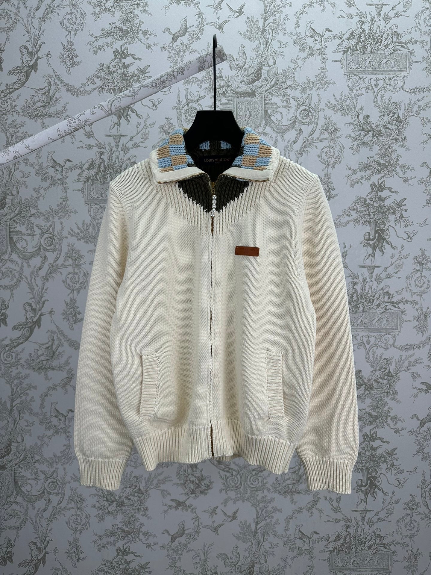 Cream knit cardigan with full zipper and striped ribbed collar detail