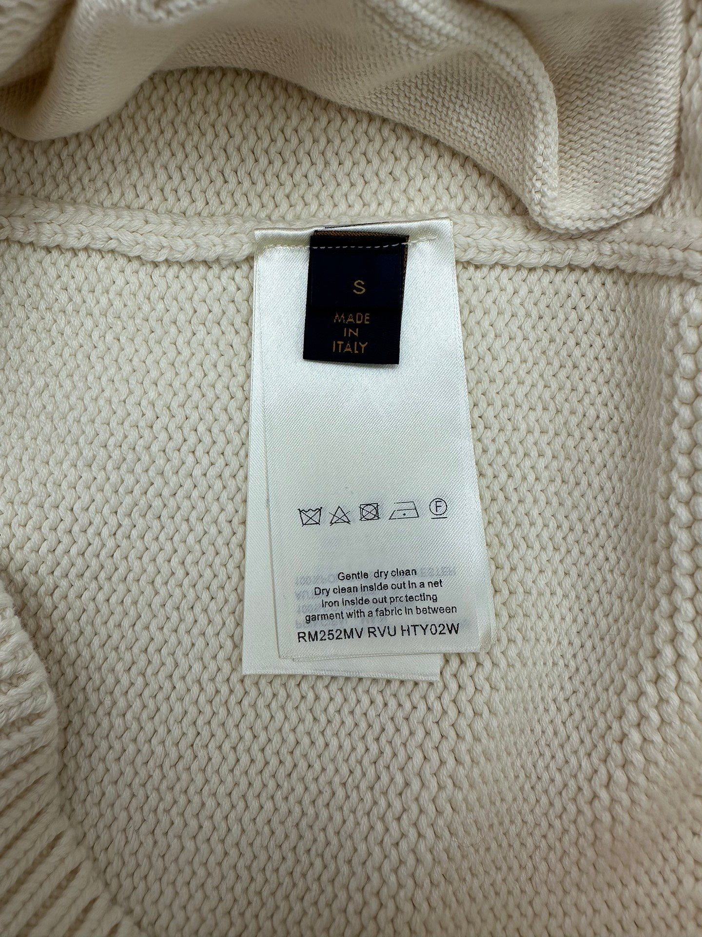 Cream knit cardigan interior care label, made in Italy text