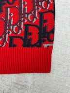 Dior knit sweater lower hem with red ribbed trim and dark blue logo pattern
