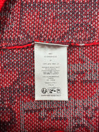 Dior sweater care label on dark red and dark blue textured knit fabric