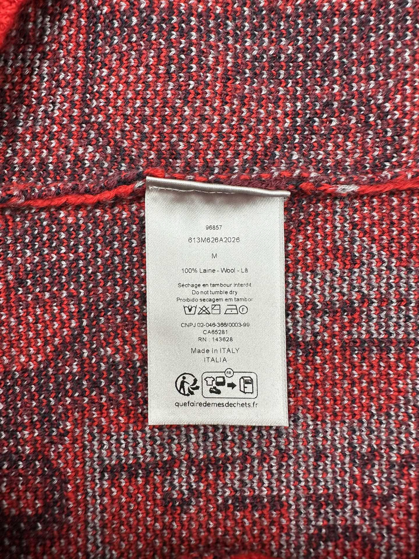 Dior sweater care label on dark red and dark blue textured knit fabric