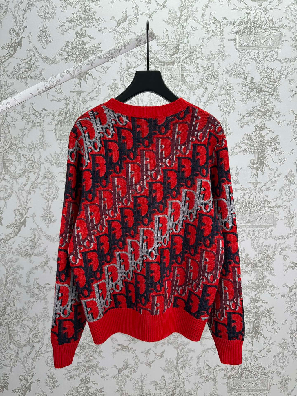 Dior knit sweater in red and dark blue with repeating logo pattern, ribbed hem