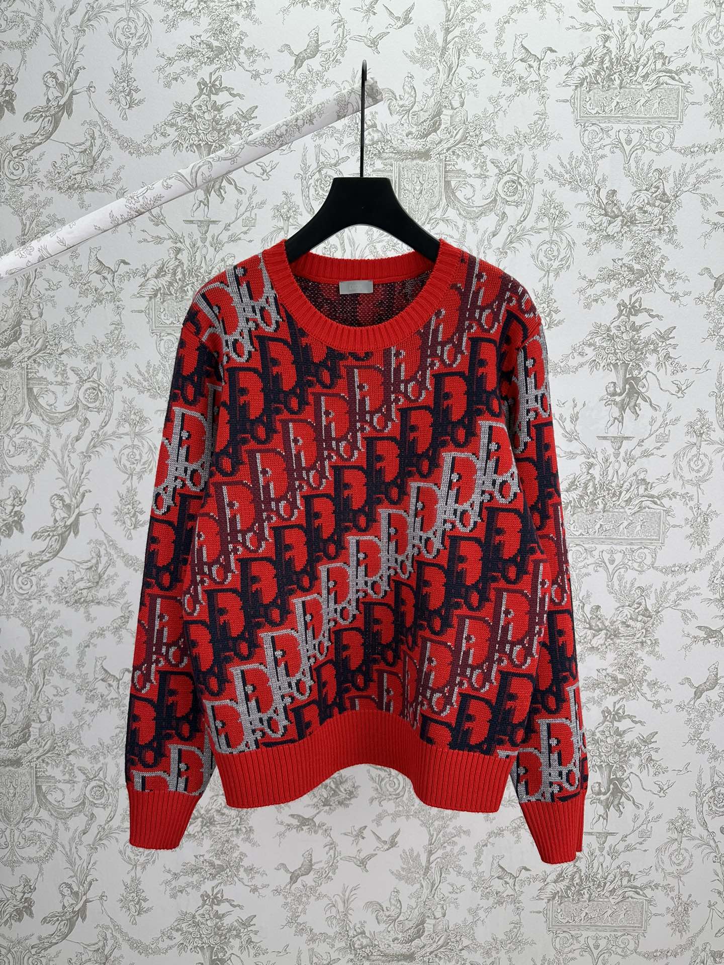 Dior knit sweater in red and dark blue with repeating logo pattern, ribbed crewneck