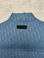 Blue Dior monogram puffer vest back view with Dior logo patch at the neck.