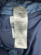 Blue Dior monogram puffer vest care label and fabric tag inside lining.
