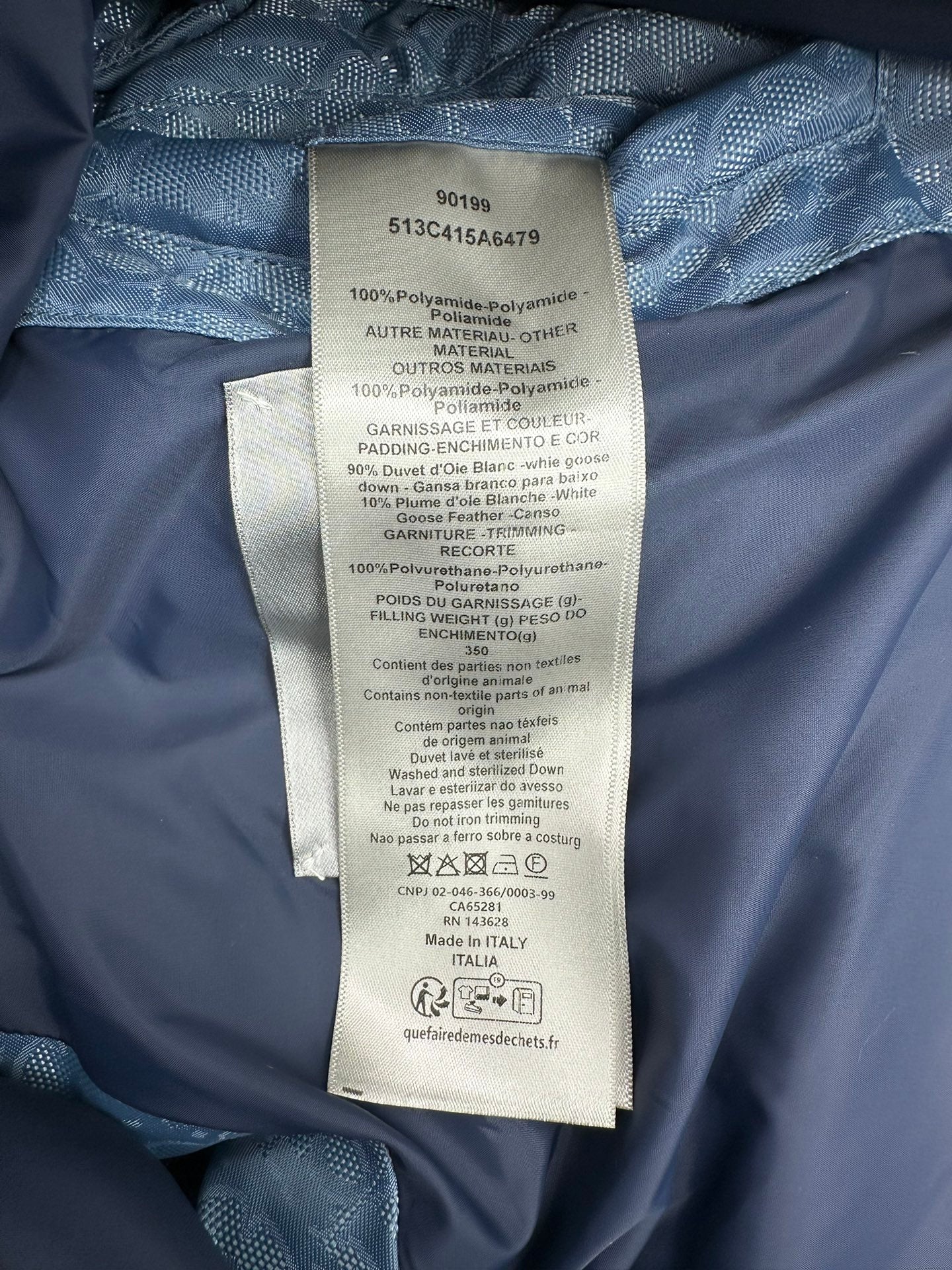 Blue Dior monogram puffer vest care label and fabric tag inside lining.