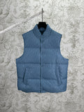 Blue Dior monogram puffer vest, sleeveless with stand collar and snap front.
