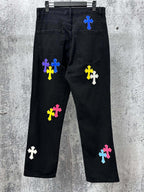Black denim pants with multicolor cross patches on legs and back pockets
