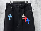 Black denim pants with light-blue and red cross patches on front