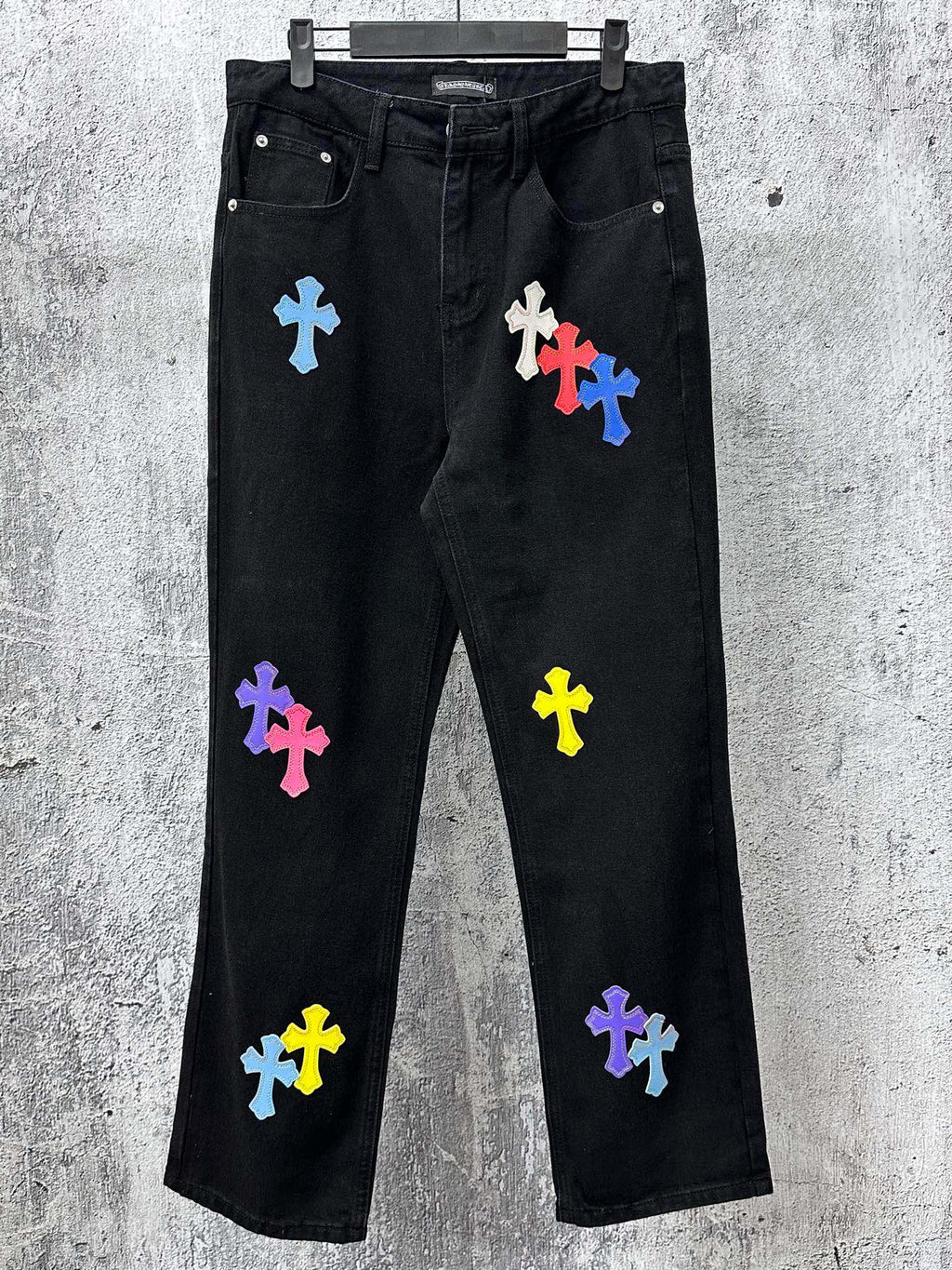 Black denim pants with multicolor cross patches, straight leg