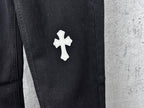 Dark denim pants with small white cross patch on thigh