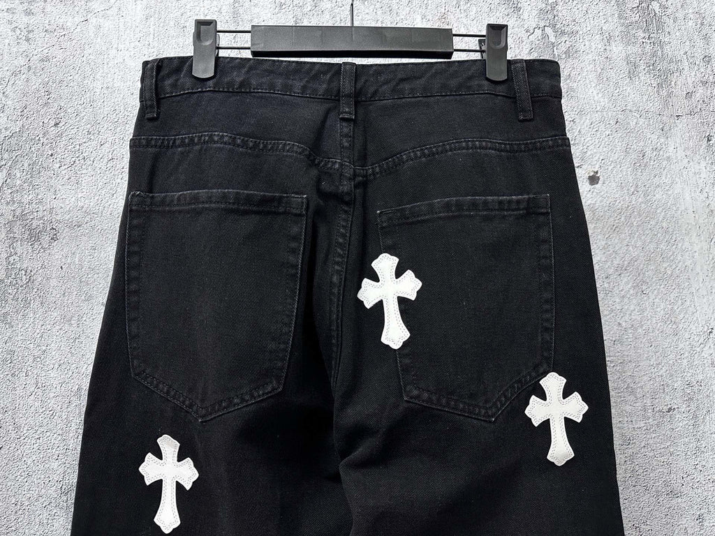 Dark denim pants with white cross patches on legs and side pockets