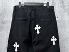 Dark denim pants with white cross patches on legs and side pockets