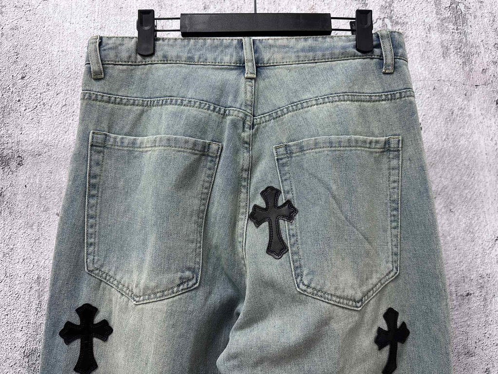 Light blue denim pants back view with pockets and black cross patches