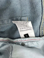 Light blue denim pants with size label and care tag, size S