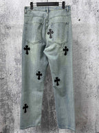 Light blue denim pants with black cross patches on front