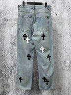 Light-wash denim pants with scattered cross patches and back pockets