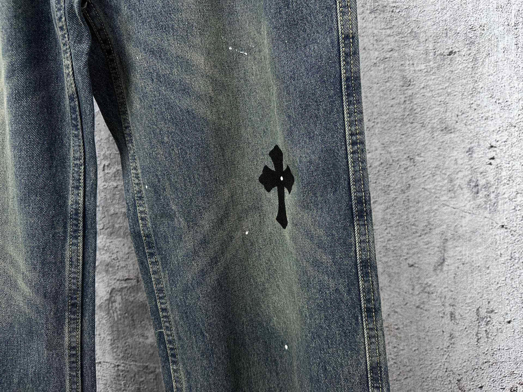 Blue denim jeans pants with a black cross graphic on the thigh