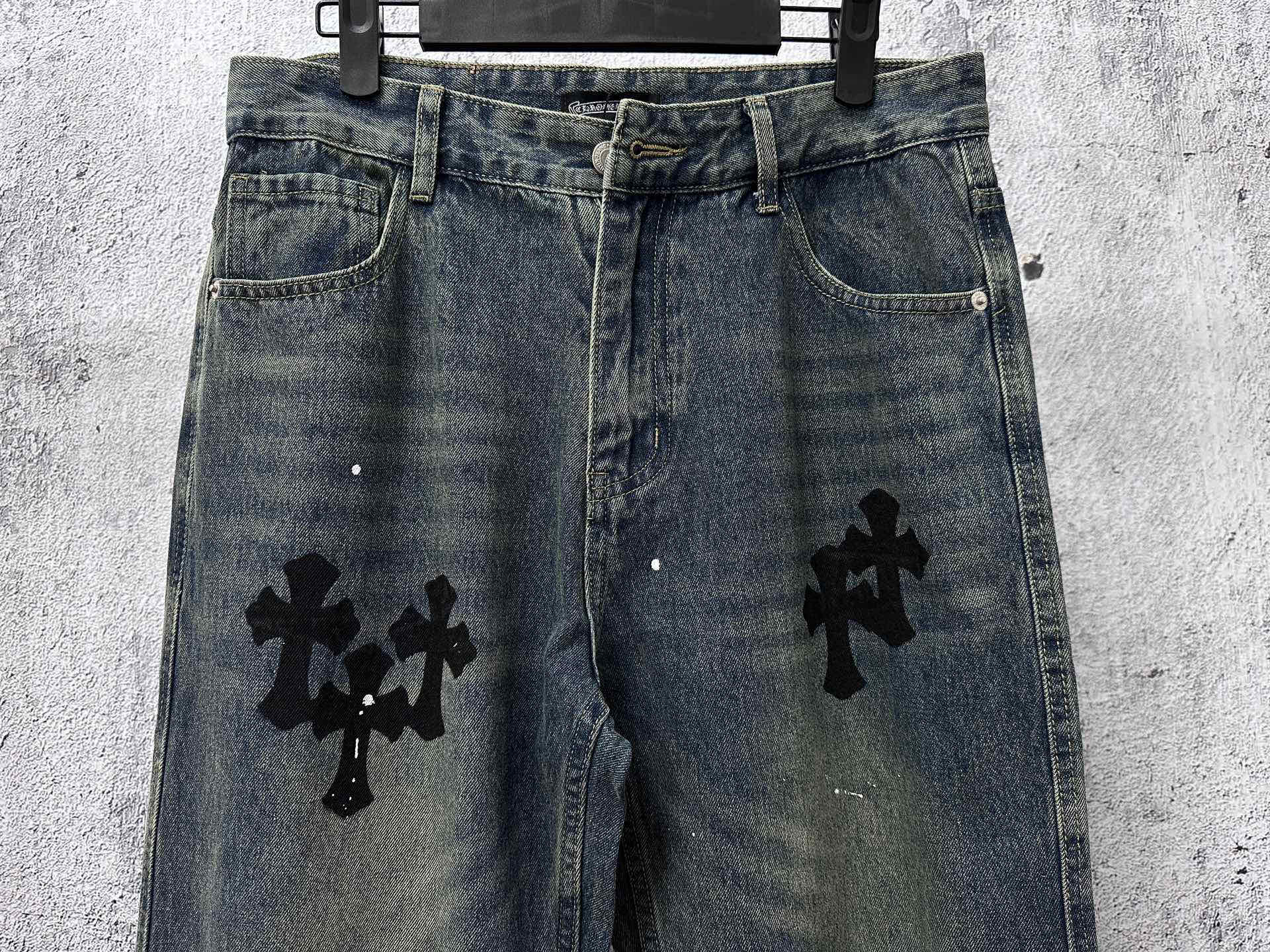 Blue denim jeans pants with black cross graphics on the back legs