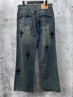 Blue denim jeans pants with black cross-like graphic patches and front pockets