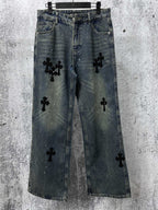 Blue denim jeans pants with black cross-like graphic patches on the legs