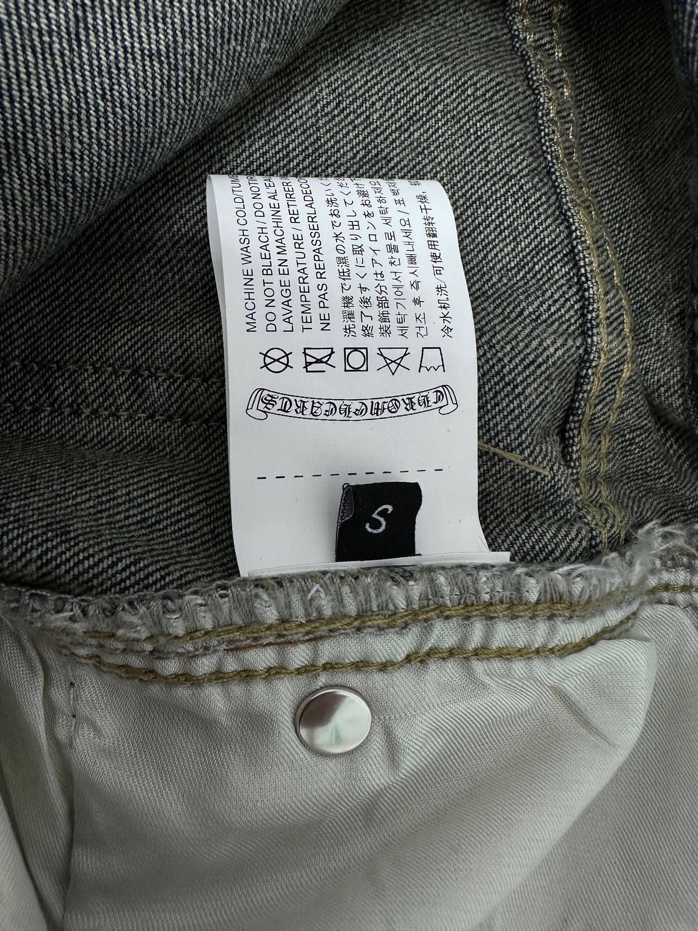Denim pants care label and size tag sewn inside the waistband