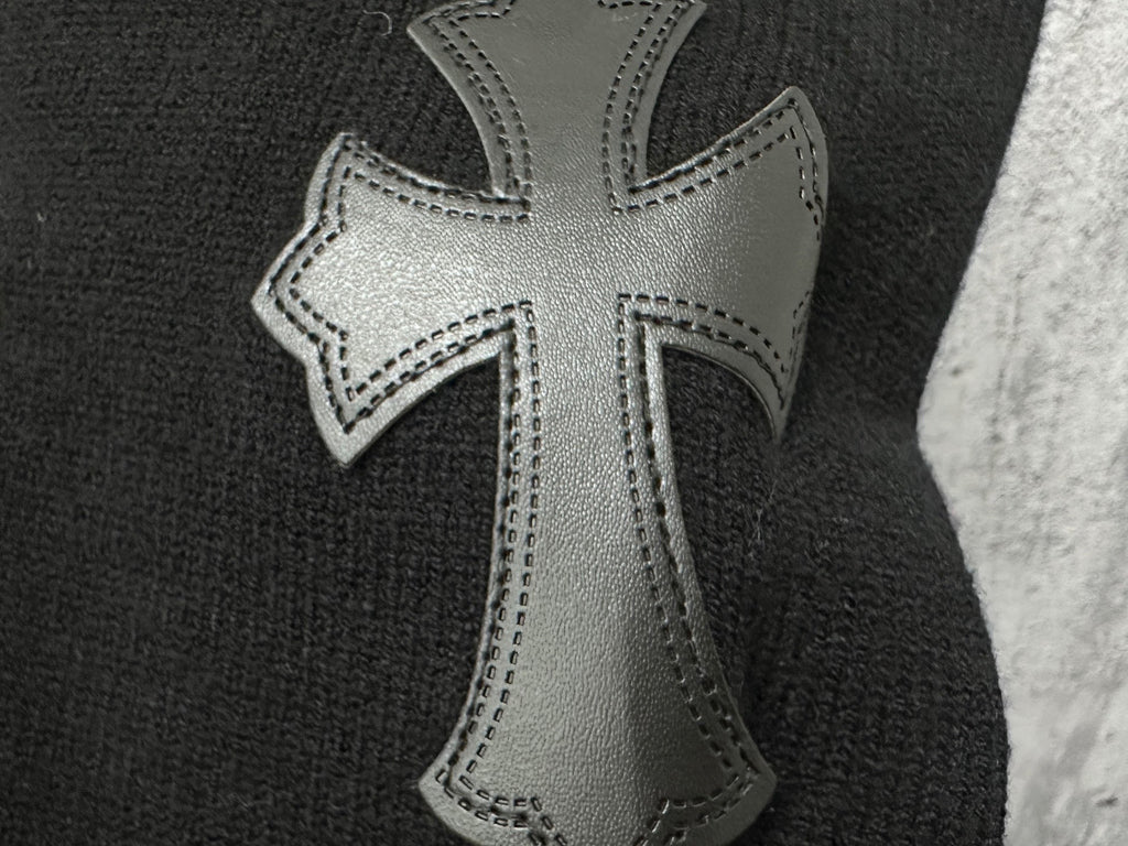 Black sweater with silver-tone cross applique with stitched edges