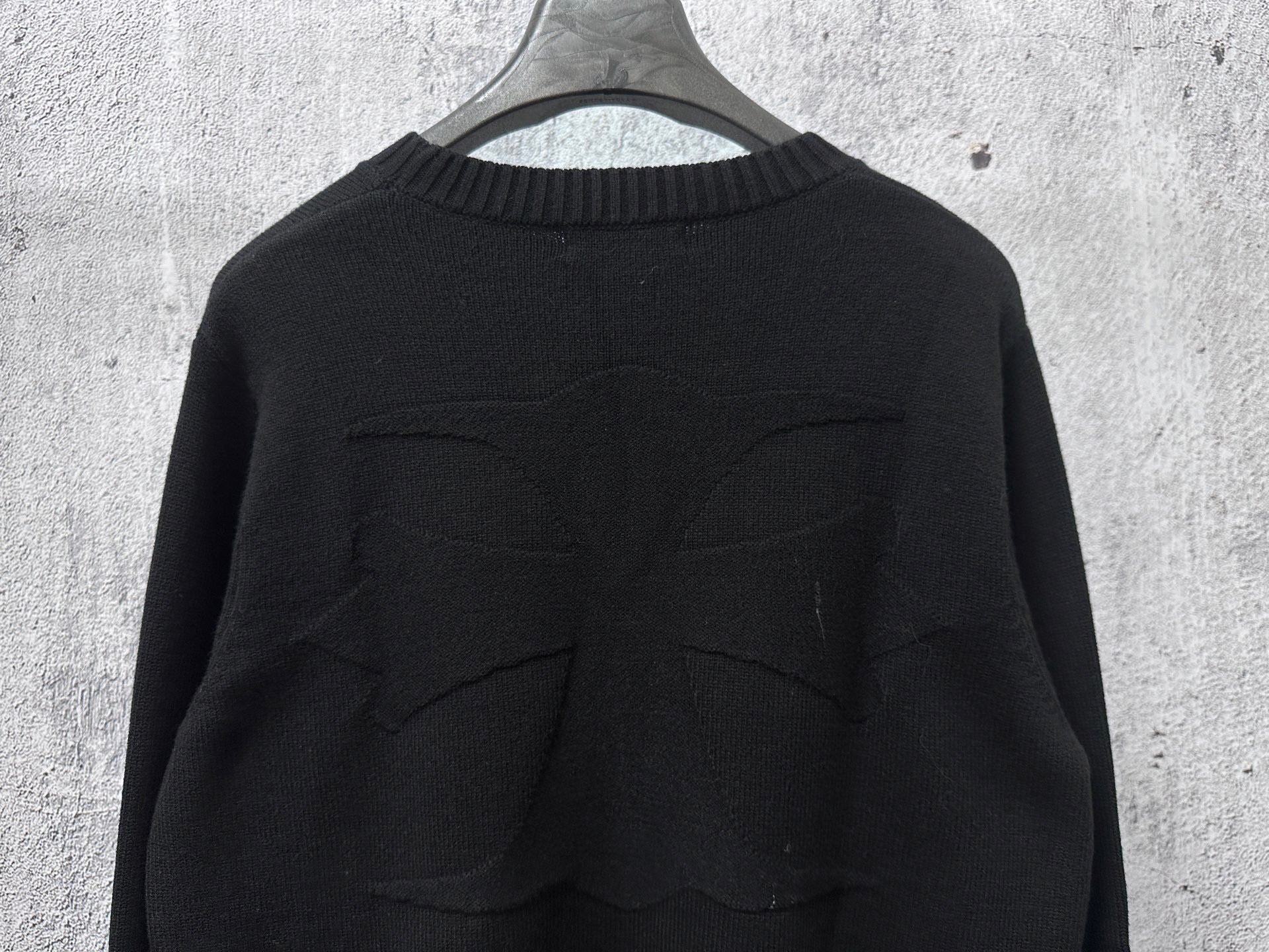 Black knit sweater back with stitched seam detailing