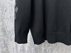 Black long-sleeve knit sweater with ribbed hem and cuff detail
