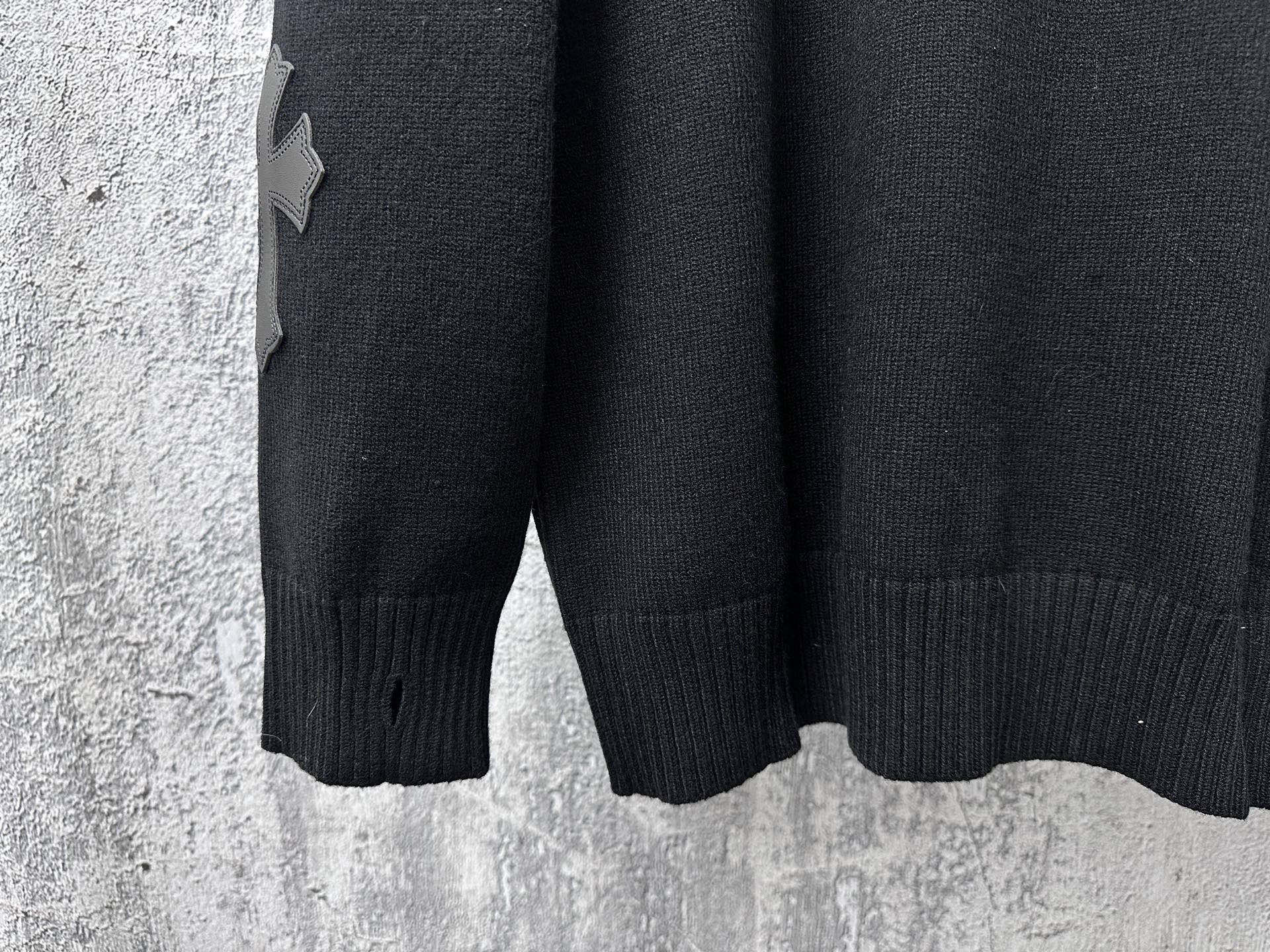 Black long-sleeve knit sweater with ribbed hem and cuff detail