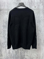 Black long-sleeve knit sweater, back view with ribbed hem and cuffs