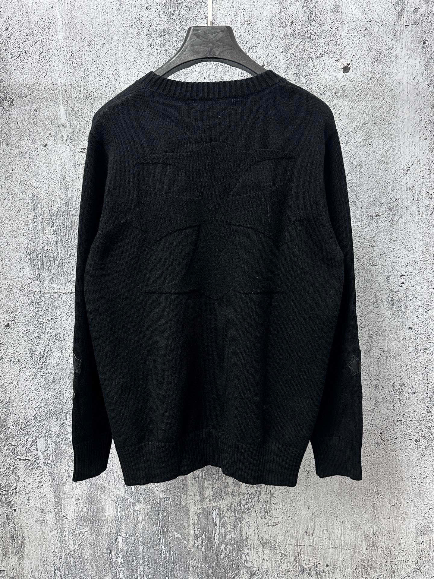 Black long-sleeve knit sweater, back view with ribbed hem and cuffs