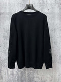 Black long-sleeve knit sweater with ribbed crew neck and cuffs