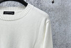 Light long-sleeve sweater neckline with black brand tag