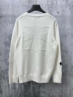Light long-sleeve sweater with large stitched cross graphic on back