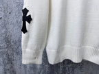 Light long-sleeve sweater with black cross detail on sleeve cuff