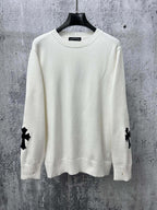 Light long-sleeve sweater with crew neck and black cross patches on sleeves