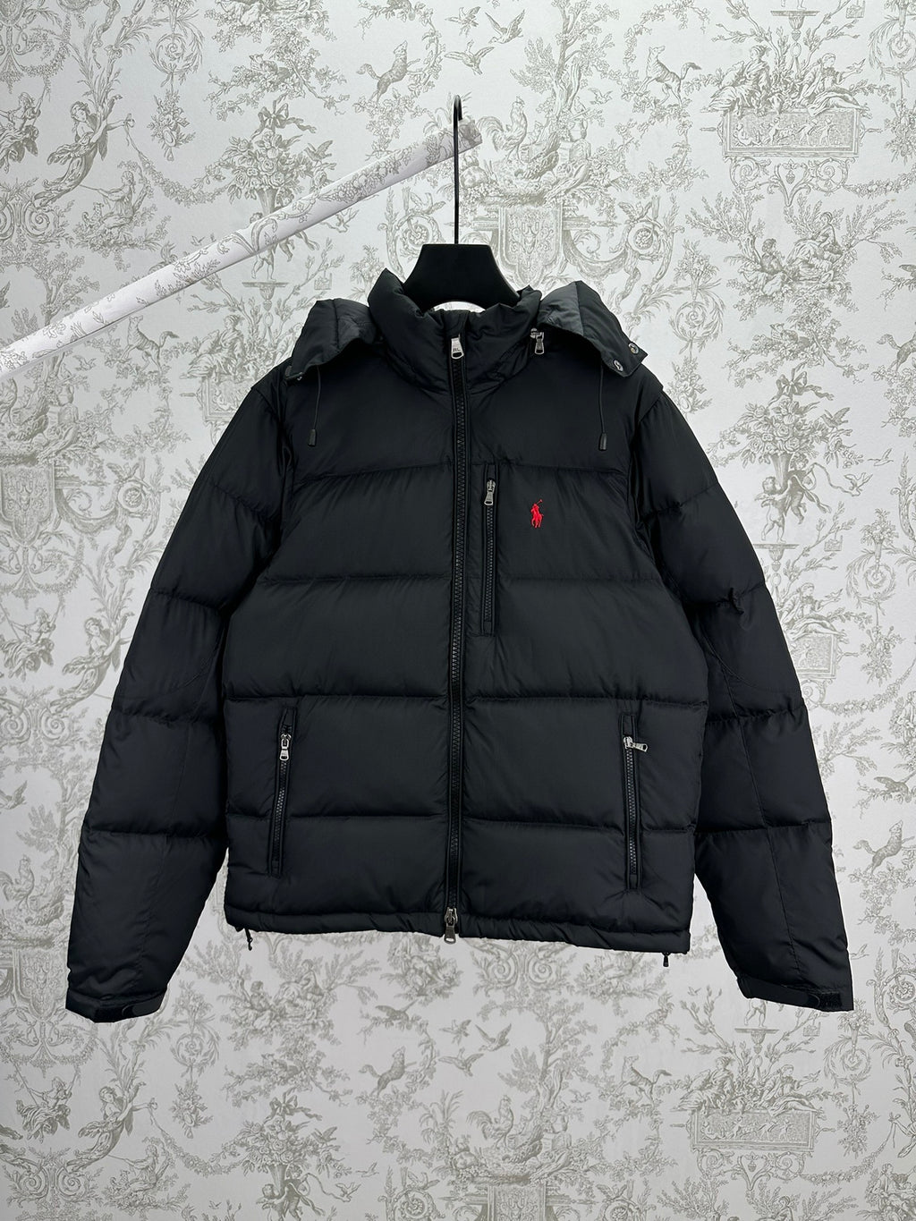 Dark puffer jacket with full-zip front, hood, and side pockets