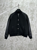 Black bomber jacket with snap button placket and ribbed cuffs