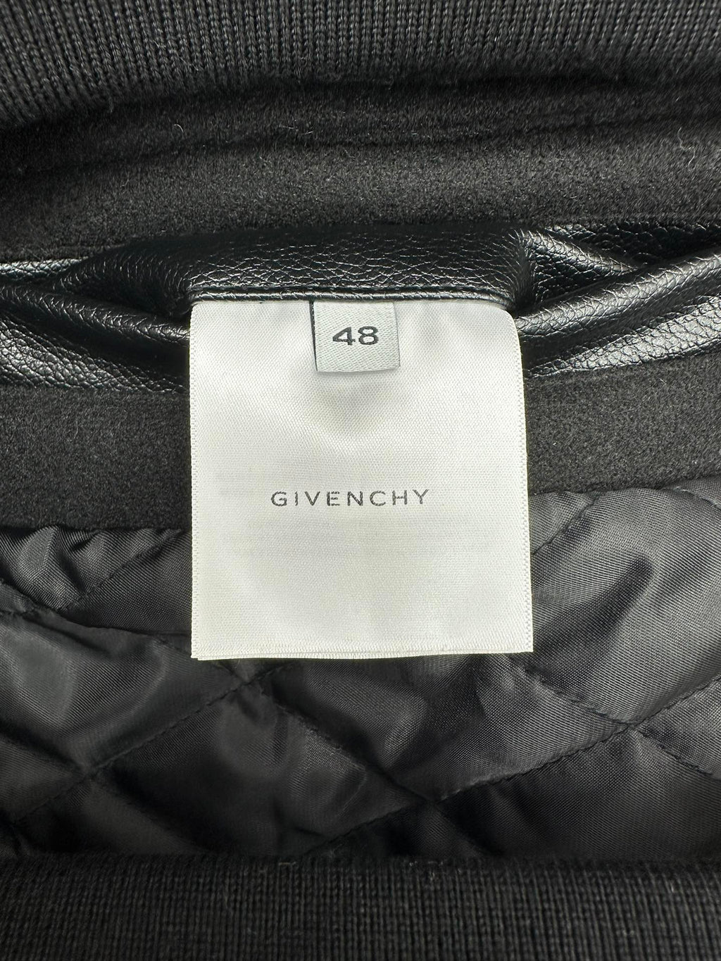 Black bomber jacket with Givenchy size tag 48 on quilted inner lining