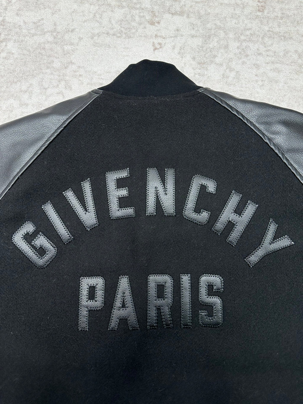 Black bomber jacket with large Givenchy Paris lettering on back
