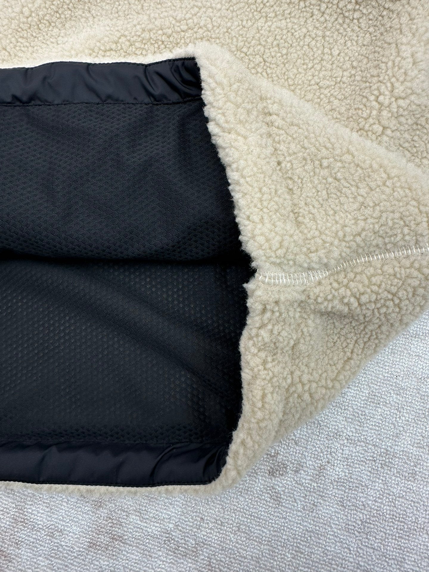 Cream sherpa jacket lining and side opening with dark interior panel